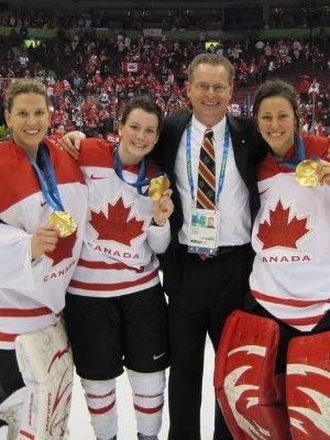 assistant coach of the 2010 Canadian Olympic team, poseg with McGill players Kim St-Pierre, left, Catherine Ward and Charline Labonte after winning gold at the Vancouver Olympics.